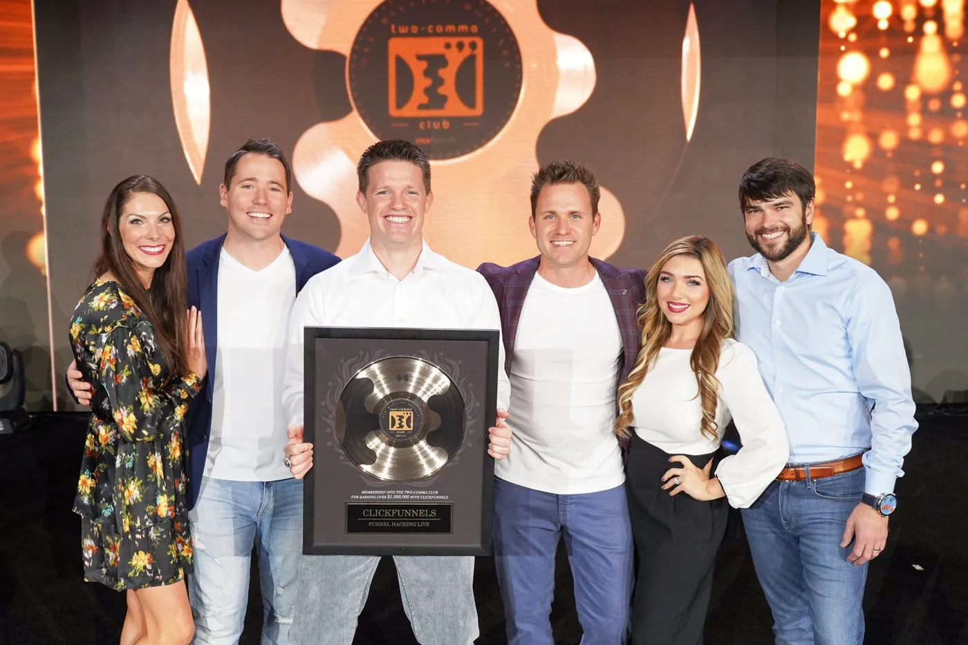 Stephanie and Bryan Dulaney with friends and a Two Comma Club award