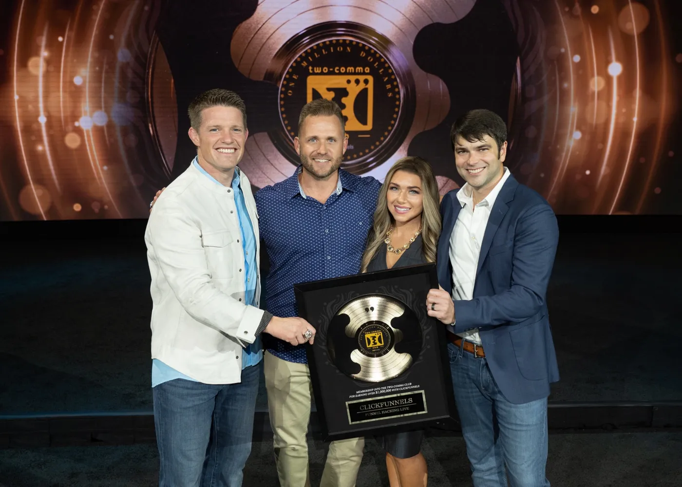 Stephanie and Bryan Dulaney receiving a Two Comma Club award