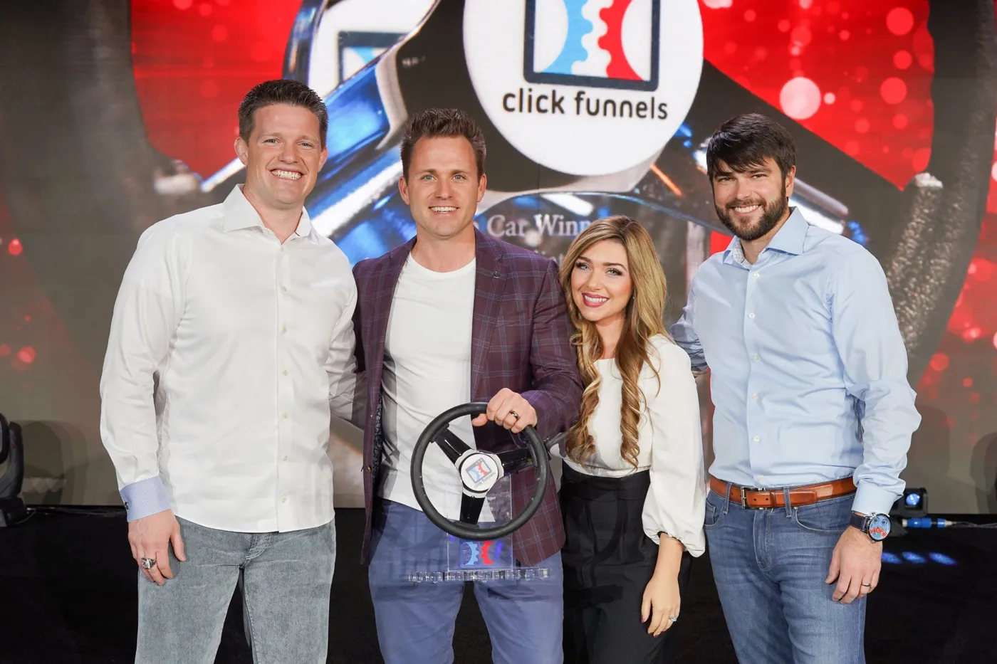 Stephanie and Bryan Dulaney with a ClickFunnels car winner award
