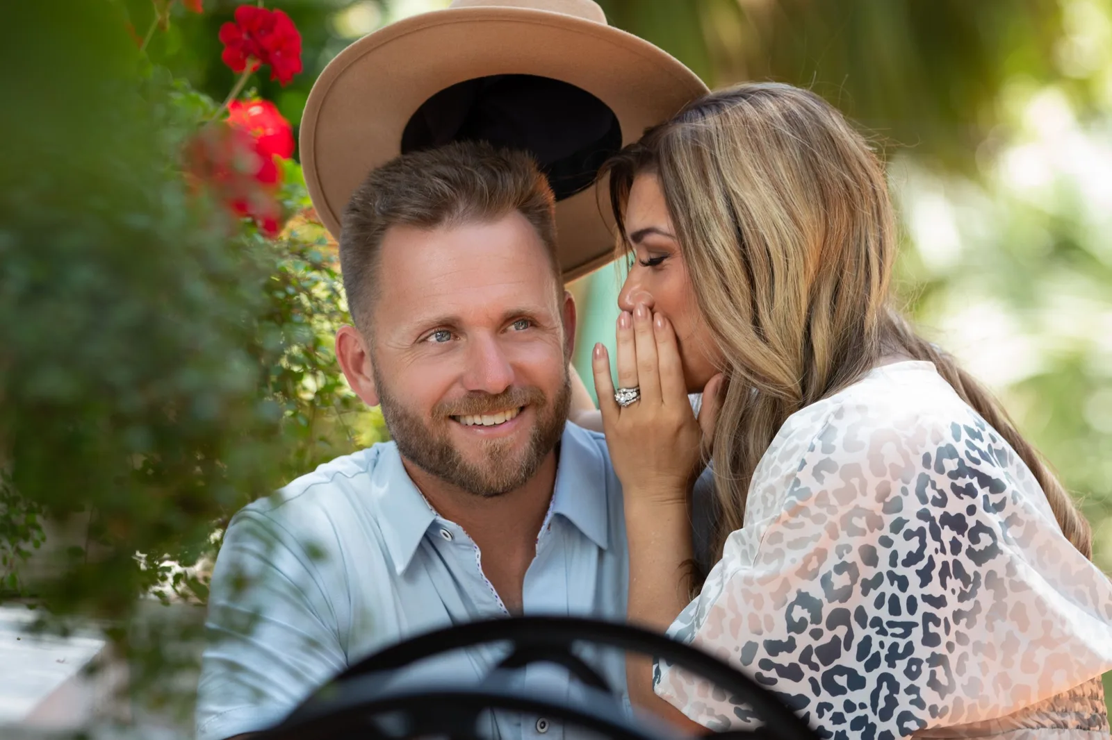 Stephanie whispering to Bryan Dulaney